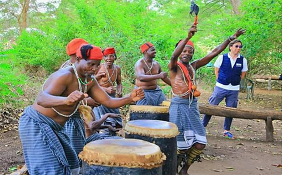 Dawida dancers performing the Mwazindika dance around large drums.